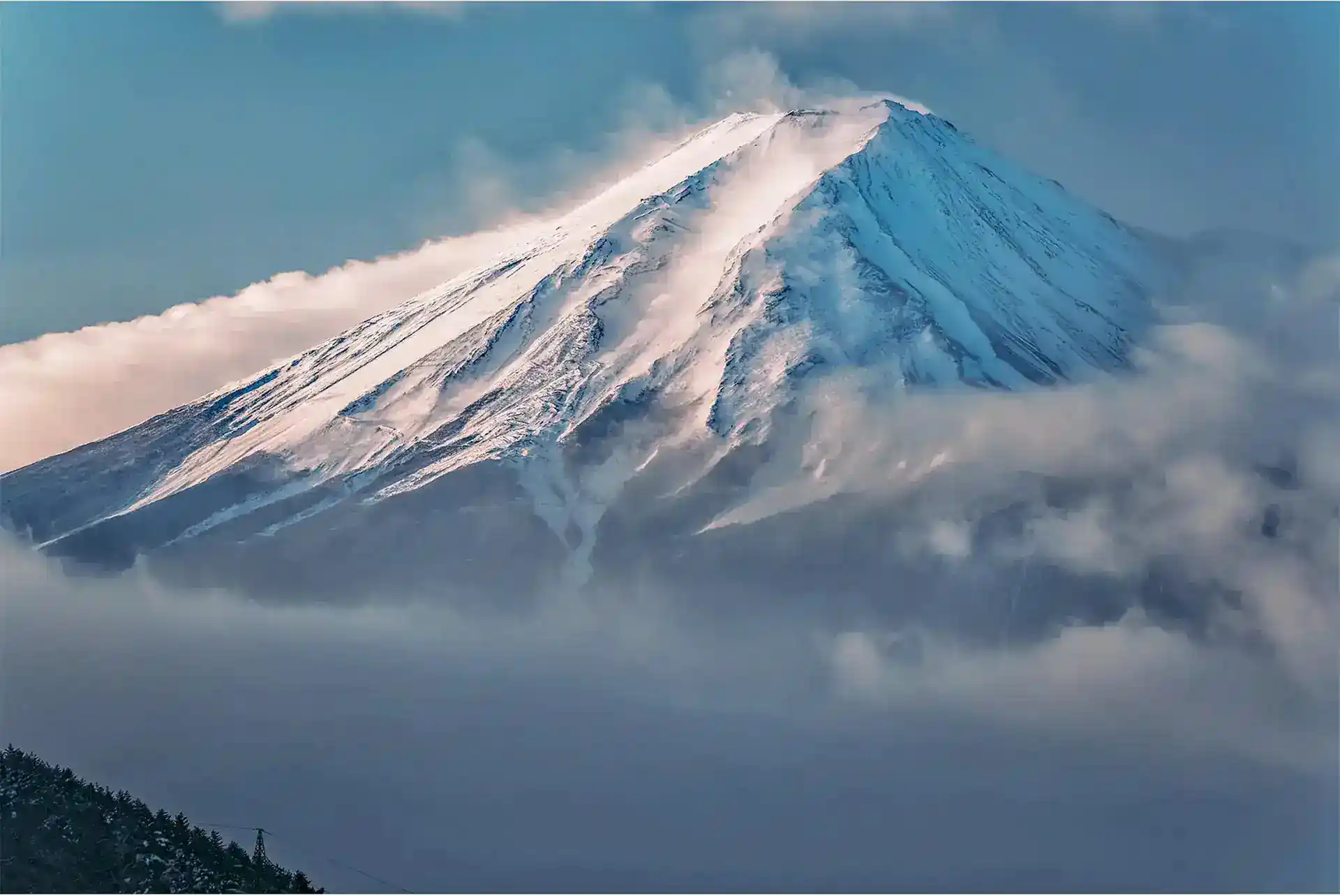 Iconic Mount Fuji winter landscape: A majestic telephoto shot of the snow-capped peak from Lake Kawaguchiko.
